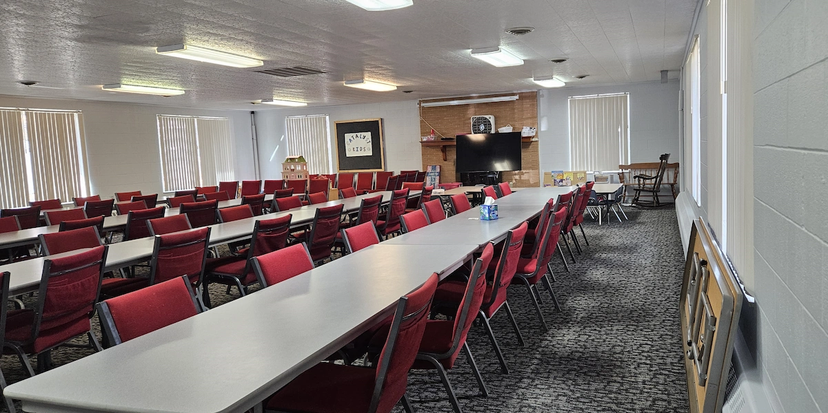 Room showing layout of rectangular tables with chairs around each.
